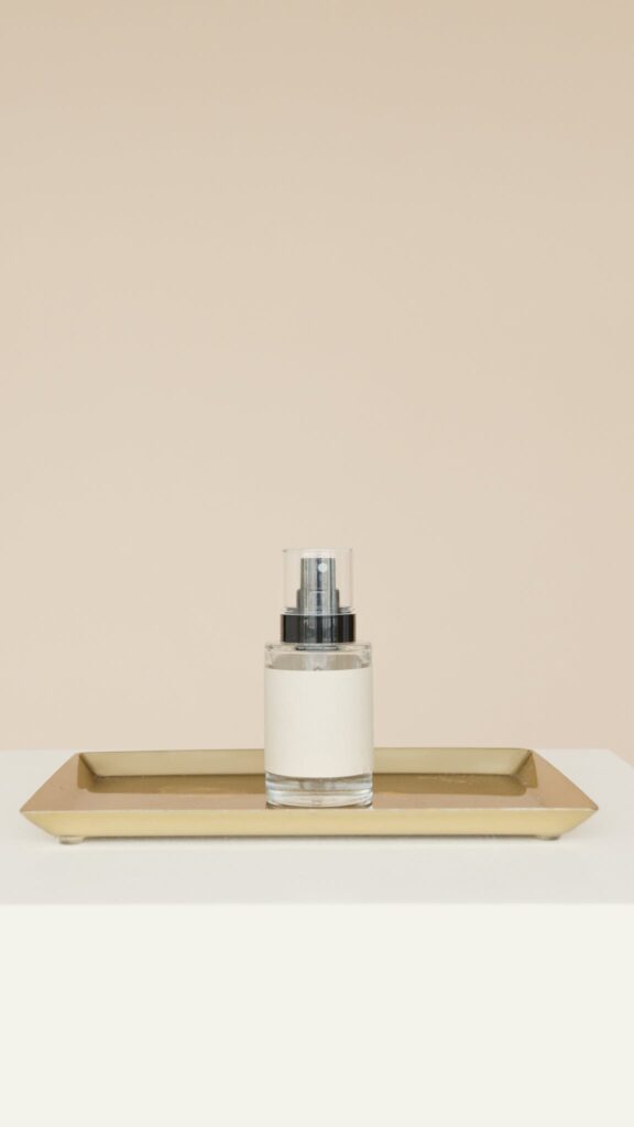 White and Silver Bottle on Brown Wooden Tray